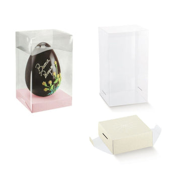 Scatola trasparente porta uovo, mostrata con uovo di pasqua all'interno, e vuota e base porta uova bianca mostrata fuori